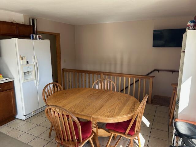 dining space featuring light tile patterned floors