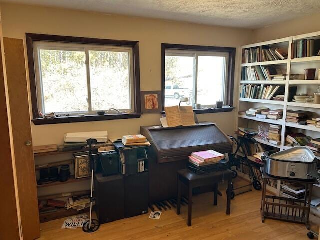 office space with a textured ceiling and wood finished floors