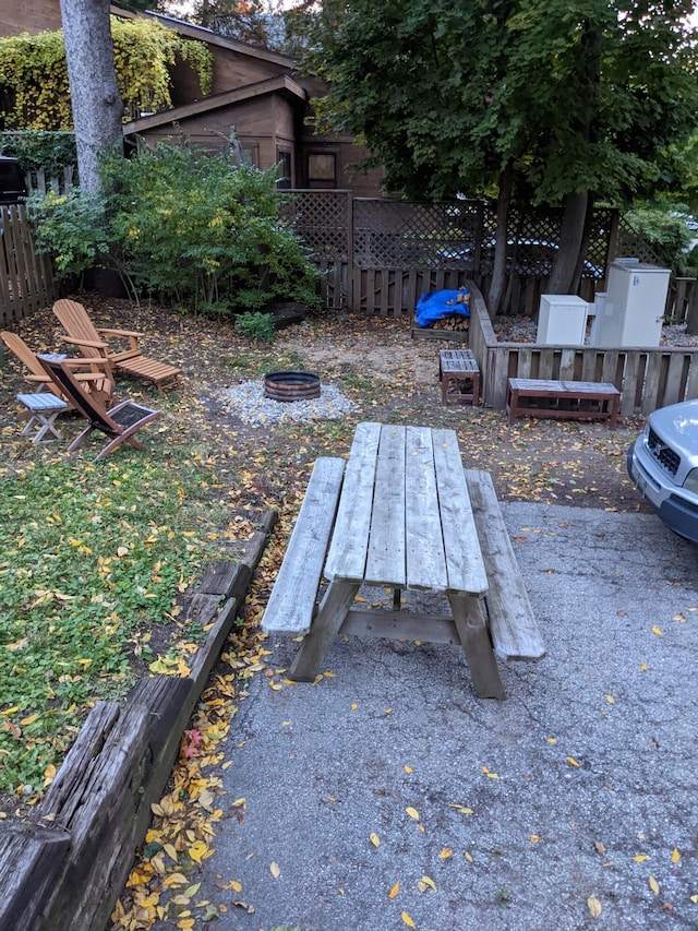 view of yard featuring fence and a fire pit