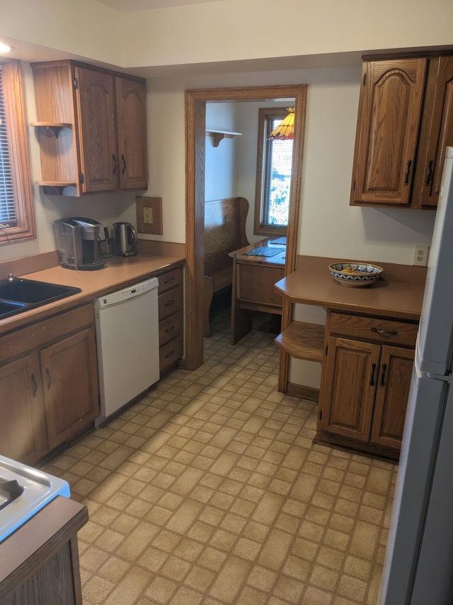 kitchen featuring a sink, open shelves, and white appliances