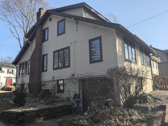 view of property exterior with a chimney