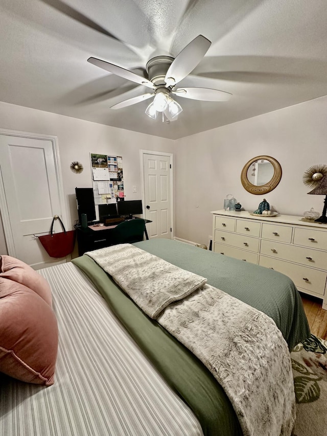 bedroom with light wood finished floors and ceiling fan