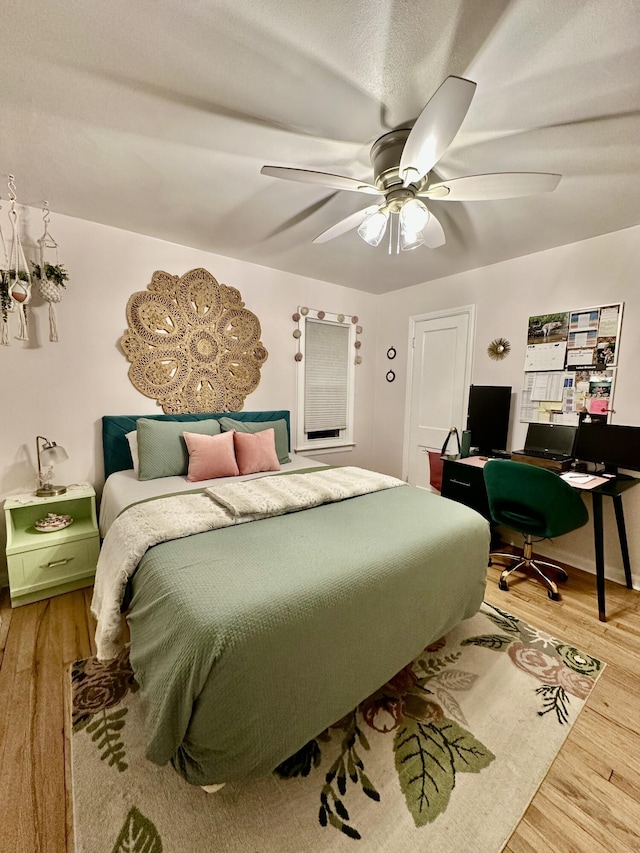 bedroom with wood finished floors and a ceiling fan