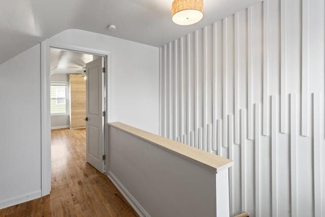 corridor featuring vaulted ceiling and hardwood / wood-style flooring