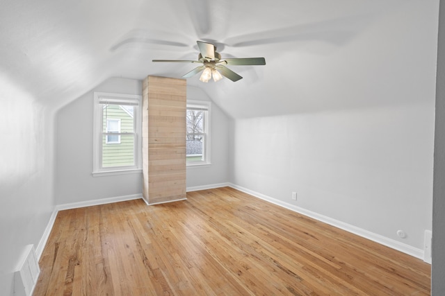 bonus room featuring a ceiling fan, visible vents, baseboards, light wood-style flooring, and vaulted ceiling