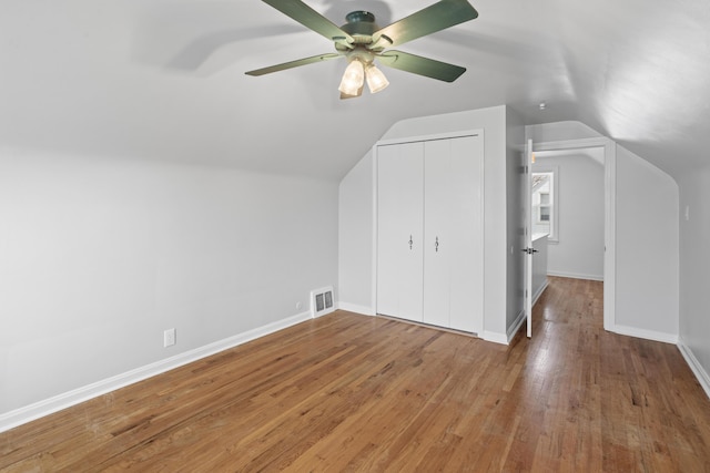 bonus room with visible vents, baseboards, vaulted ceiling, hardwood / wood-style flooring, and a ceiling fan