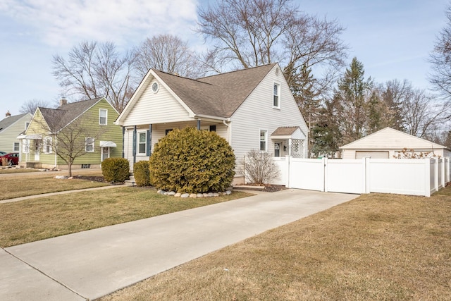 view of home's exterior with a gate, a lawn, roof with shingles, and fence