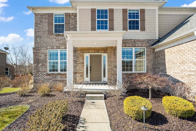 entrance to property featuring brick siding