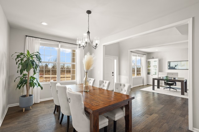 dining space with dark wood-type flooring, recessed lighting, baseboards, and a chandelier