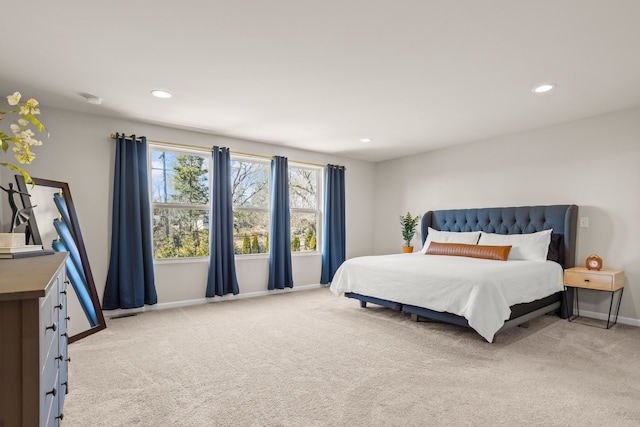 bedroom with recessed lighting, baseboards, and light carpet