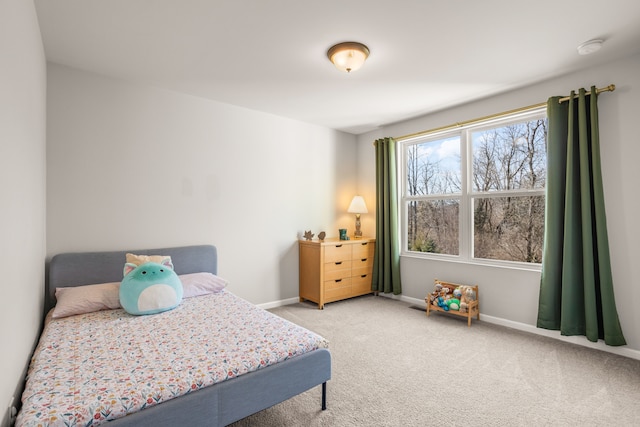 carpeted bedroom featuring baseboards