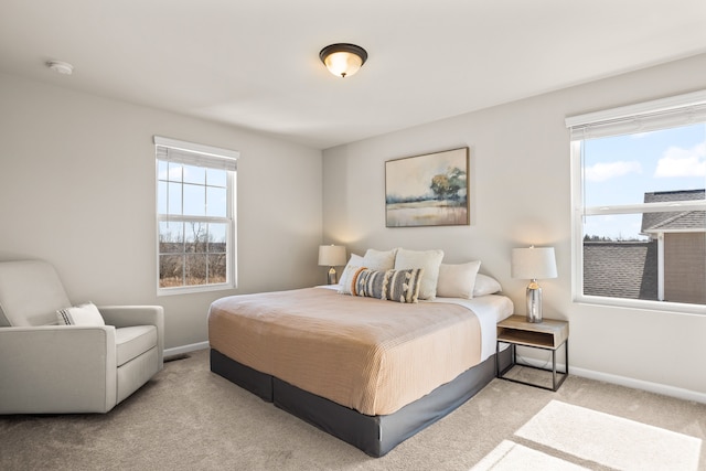 bedroom with multiple windows, carpet, and baseboards