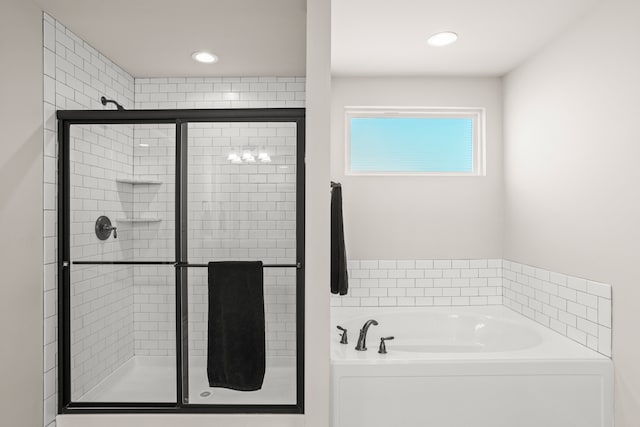 full bathroom featuring recessed lighting, a stall shower, and a bath