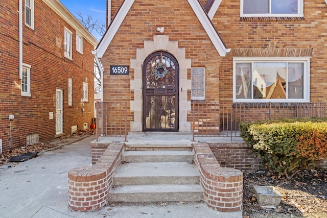 property entrance featuring brick siding