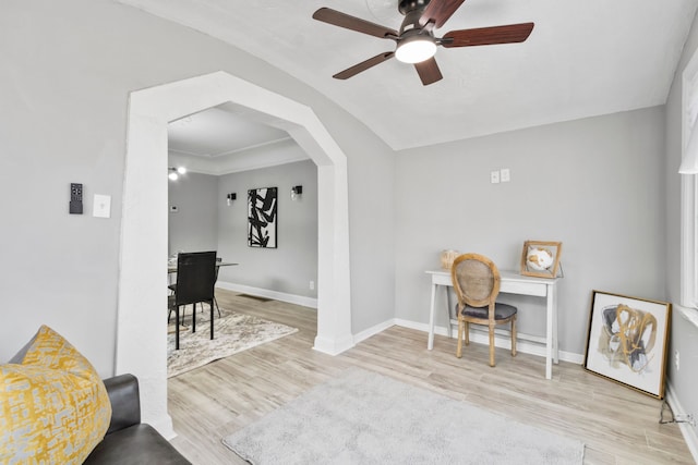 office area with visible vents, wood finished floors, arched walkways, and baseboards