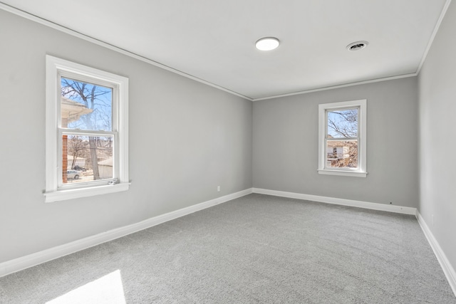 empty room with carpet, baseboards, visible vents, and ornamental molding