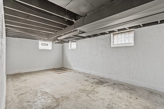 basement featuring a wealth of natural light and baseboards