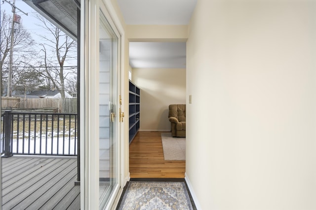 entryway with baseboards and wood finished floors