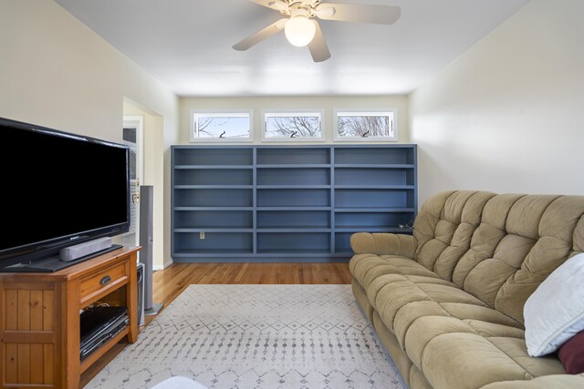 living room with a healthy amount of sunlight, light wood-type flooring, and ceiling fan