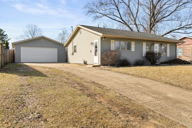 view of front facade featuring a front lawn, a detached garage, fence, an outdoor structure, and a shingled roof