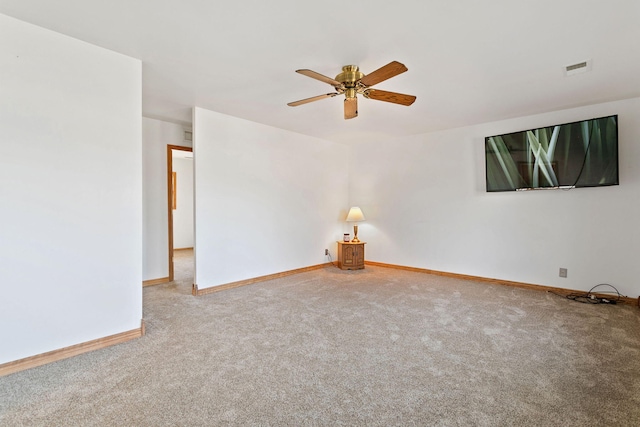 empty room with a ceiling fan, carpet, visible vents, and baseboards