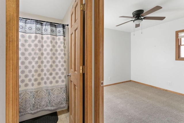 full bathroom featuring baseboards, a shower with curtain, and a ceiling fan