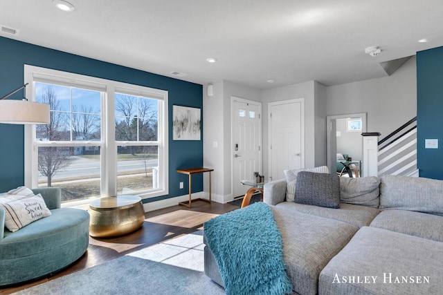 living area featuring recessed lighting, baseboards, wood finished floors, and stairs