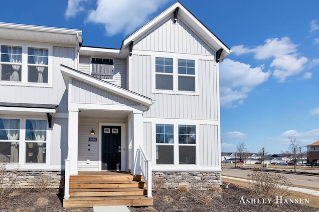 view of front of home featuring board and batten siding and stone siding