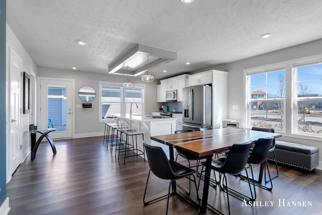 dining space with dark wood-type flooring, recessed lighting, and baseboards