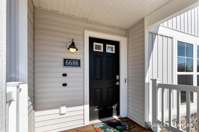 view of exterior entry featuring board and batten siding