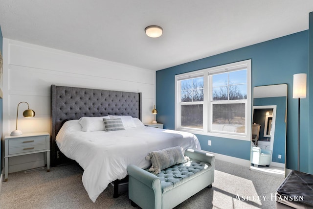 carpeted bedroom featuring baseboards