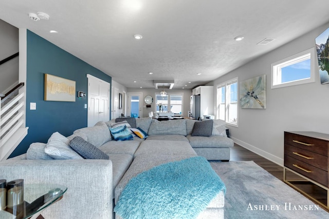 living area with dark wood finished floors, recessed lighting, baseboards, and visible vents