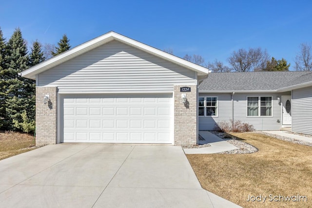 ranch-style home featuring brick siding, concrete driveway, and a garage