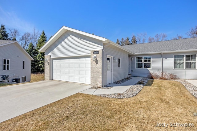 ranch-style house featuring concrete driveway, an attached garage, brick siding, and a front lawn