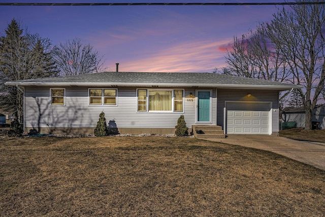 single story home featuring a garage, a lawn, concrete driveway, and a shingled roof