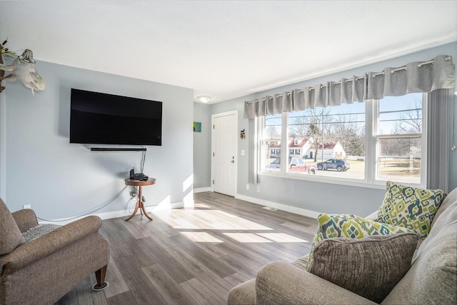 living area with wood finished floors and baseboards