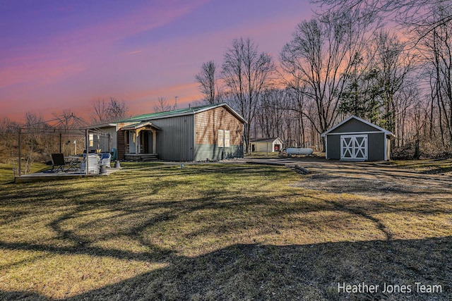 view of yard featuring entry steps, an outdoor structure, and a shed