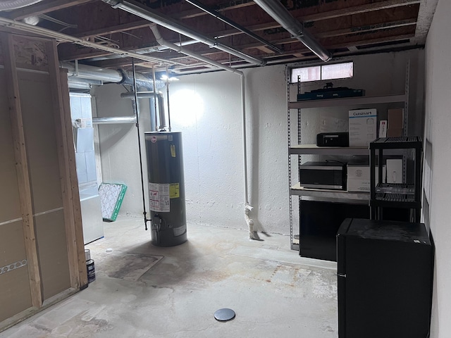 unfinished basement with water heater and fridge