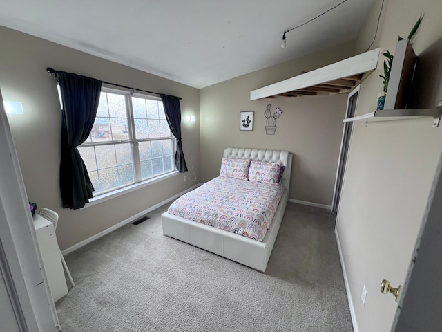 bedroom featuring visible vents, baseboards, and carpet floors