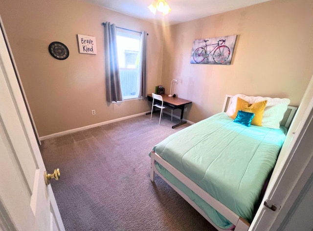 carpeted bedroom featuring baseboards