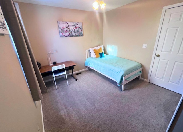 carpeted bedroom featuring visible vents and baseboards