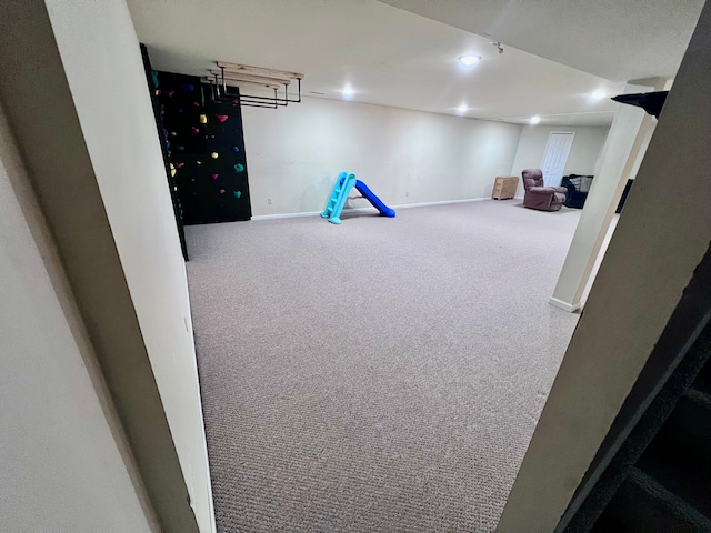 recreation room with carpet flooring, recessed lighting, and baseboards