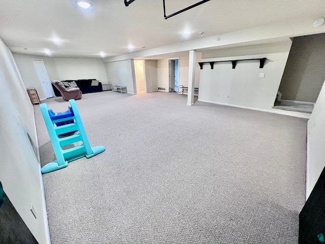 finished basement featuring baseboards and carpet floors