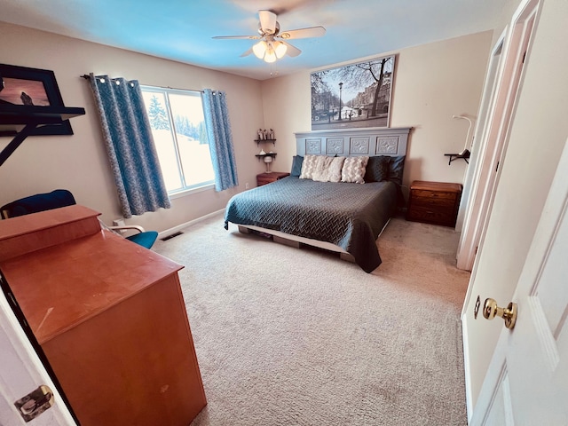 bedroom featuring baseboards, visible vents, a ceiling fan, and carpet