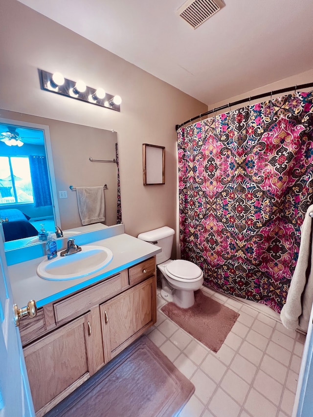 bathroom featuring visible vents, toilet, vanity, and a shower with curtain