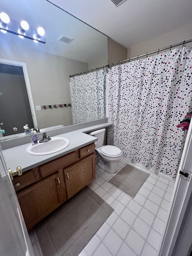 full bathroom with vanity, a shower with shower curtain, toilet, and visible vents