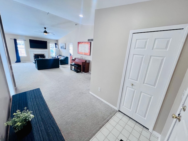 hallway with visible vents, baseboards, carpet flooring, and vaulted ceiling