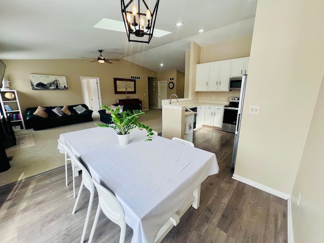 dining area with wood finished floors, baseboards, recessed lighting, ceiling fan, and vaulted ceiling