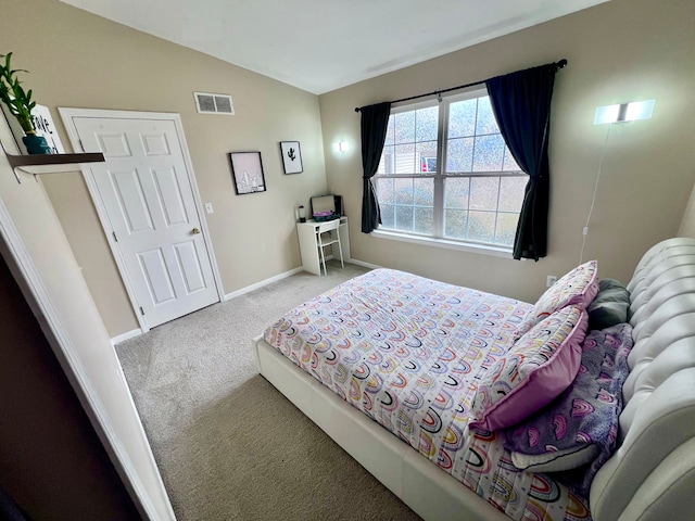 carpeted bedroom with visible vents, baseboards, and vaulted ceiling