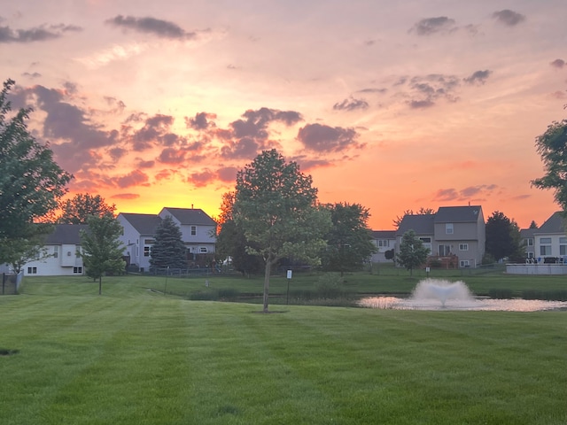 view of community featuring a yard and a water view